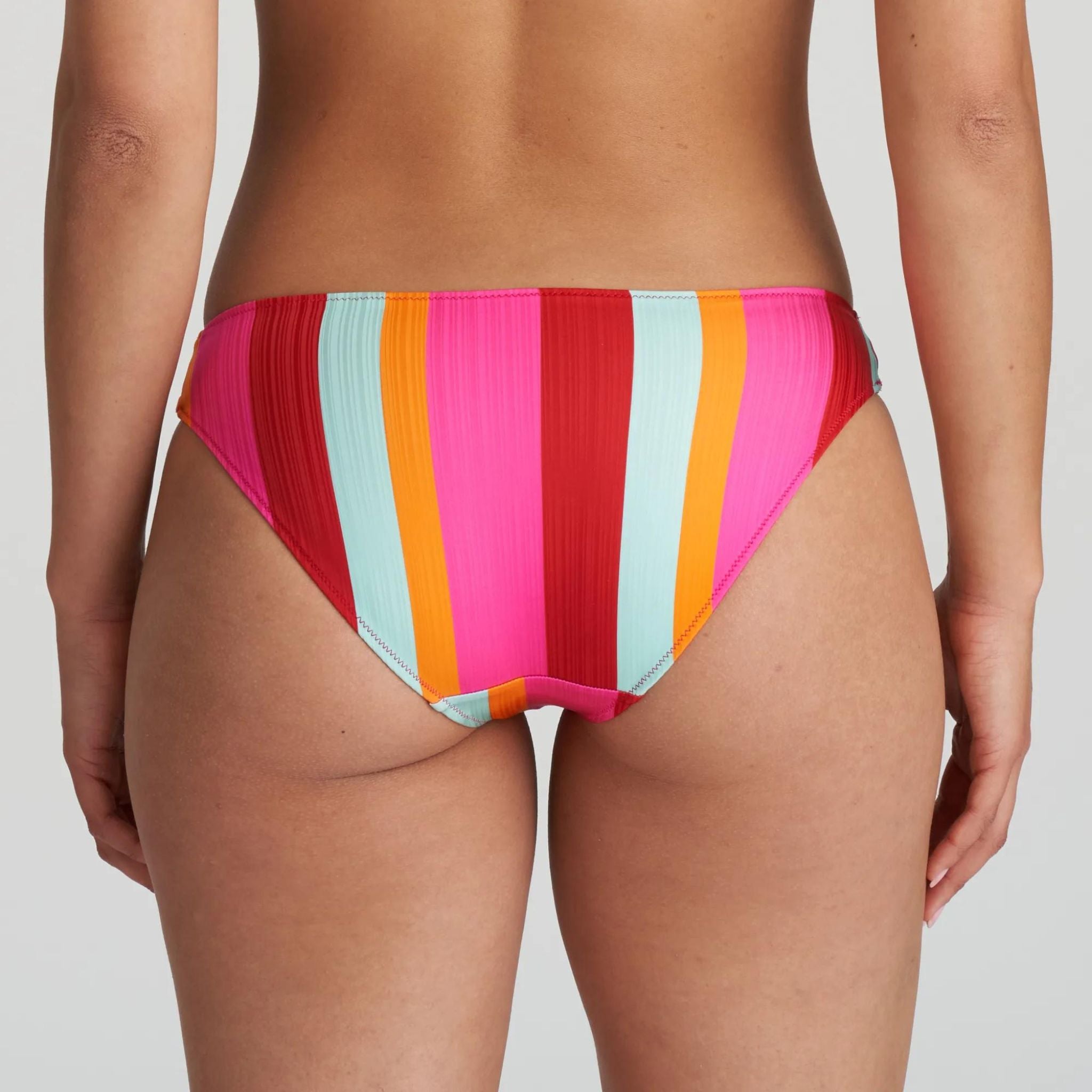 Striking rio bikini briefs with colorful, vertical stripes and bow. These jazzy colors are a feast for the eyes and make any summery beach outfit stand out from the crowd.