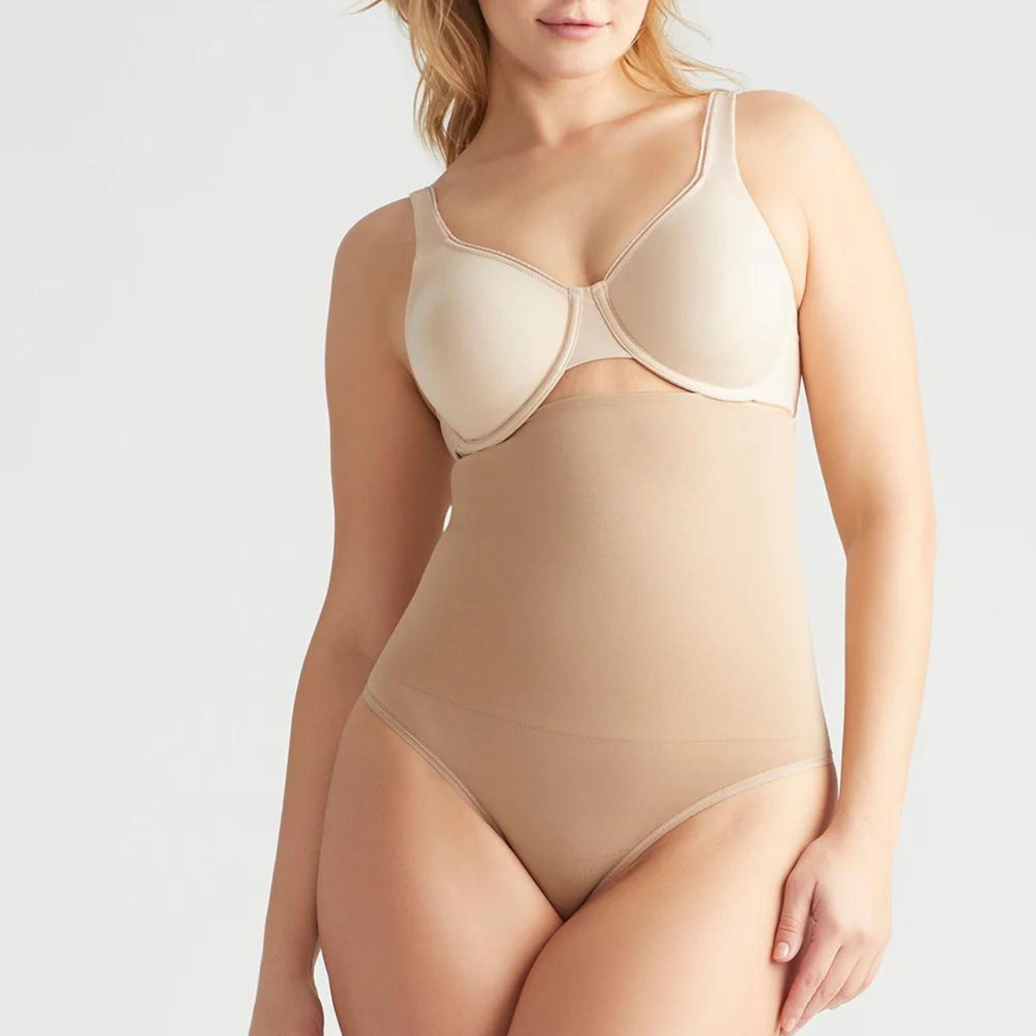 This high waist thong offers firm support and smooths your tummy with the Yummie Hug. Level 4 firm shaping Targeted waist shaping Seamless styling gives you complete allover smoothing Smooths and shapes comfortably everyday Soft silicone at waist provides no-slip confidence High-waist design sits just below the bra line Thong back for no VPL