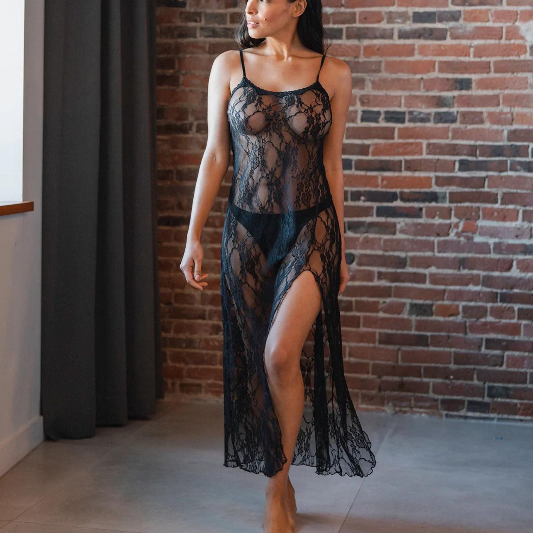 A classically sexy maxi lace chemise that leaves temptingly little to the imagination. Featuring a round neckline, thin straps, a lace trimmed top and a 48" length with a merrow finished edge. Constructed from a delicate floral lace.  Fabric: 95% Nylon 5% Elastane  Machine wash. Delicate cycle. Hang to dry.  Made in Canada