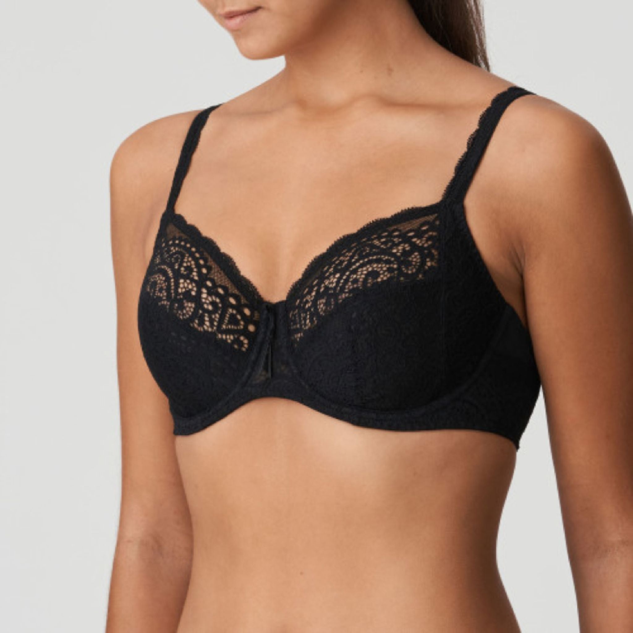 This three-piece underwire bra is feminine and comfortable. With oversized lace on the back and straps and a large satin bow on the front.