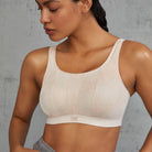 Smooth, comfy, and elegant: this streamlining underwire sports bra can be worn under virtually everything. The delicate print enhances the femininity of your silhouette and the straps can be worn over the shoulders or crossed at the back. Lovely underneath a sports top, with o