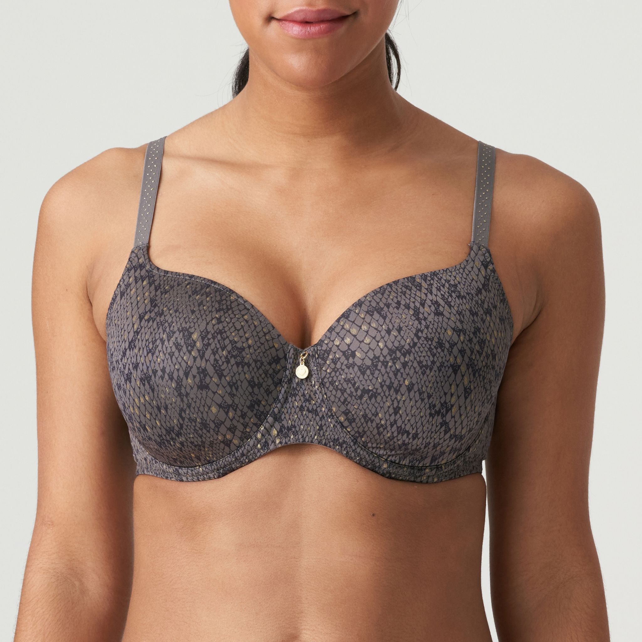 T-shirt bra with heart-shaped padded cups covered in a shimmery fabric with a snakeskin print. The straps are adorned with gold studs. Kitten Grey is a trendy snakeskin print in flattering dark grey and black.