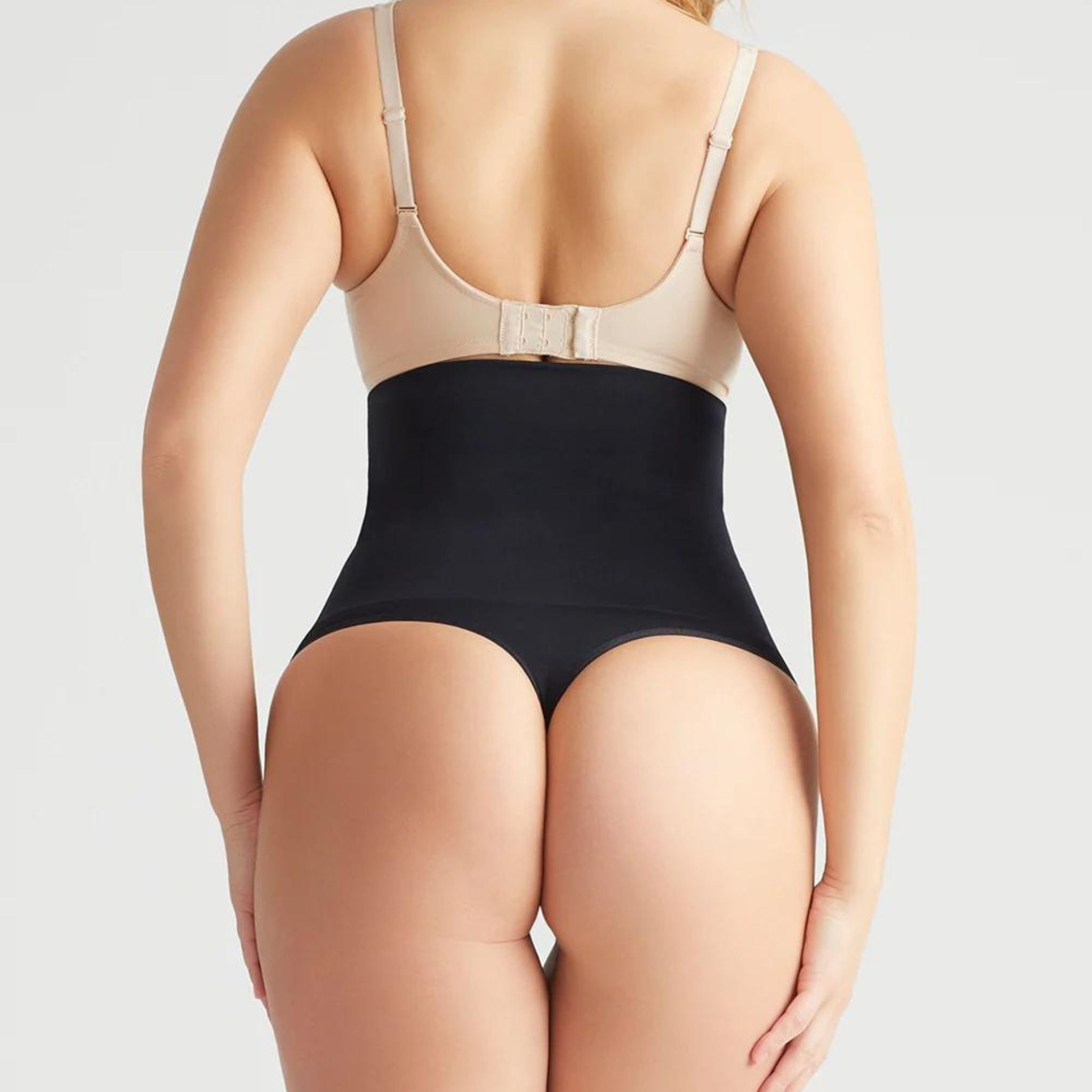 This high waist thong offers firm support and smooths your tummy with the Yummie Hug.  Level 4 firm shaping  Targeted waist shaping  Seamless styling gives you complete allover smoothing  Smooths and shapes comfortably everyday  Soft silicone at waist provides no-slip confidence  High-waist design sits just below the bra line  Thong back for no VPL